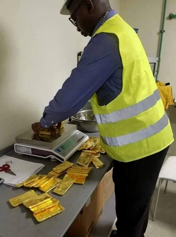 Gold being weighed and checked on a work surface